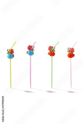 Detailed shot of multicolored curved straws decorated with bright voluminous cloth flowers. The set of flexible cocktail straws is isolated on the white background.