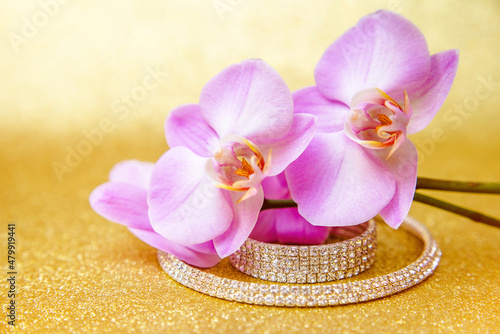 Bracelet and necklace on a gold shiny background 