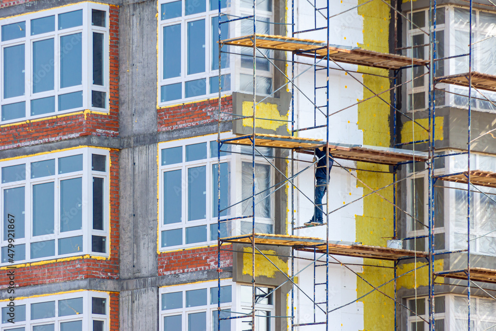 work at height to insulate the walls of a residential building using scaffolding