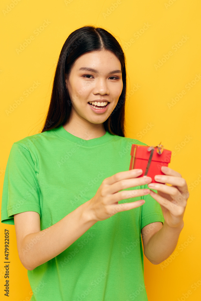 Portrait Asian beautiful young woman in green T-shirts with a small gift box studio model unaltered Portrait Asian beautiful young woman in green T-shirts with a small gift box studio model unaltered