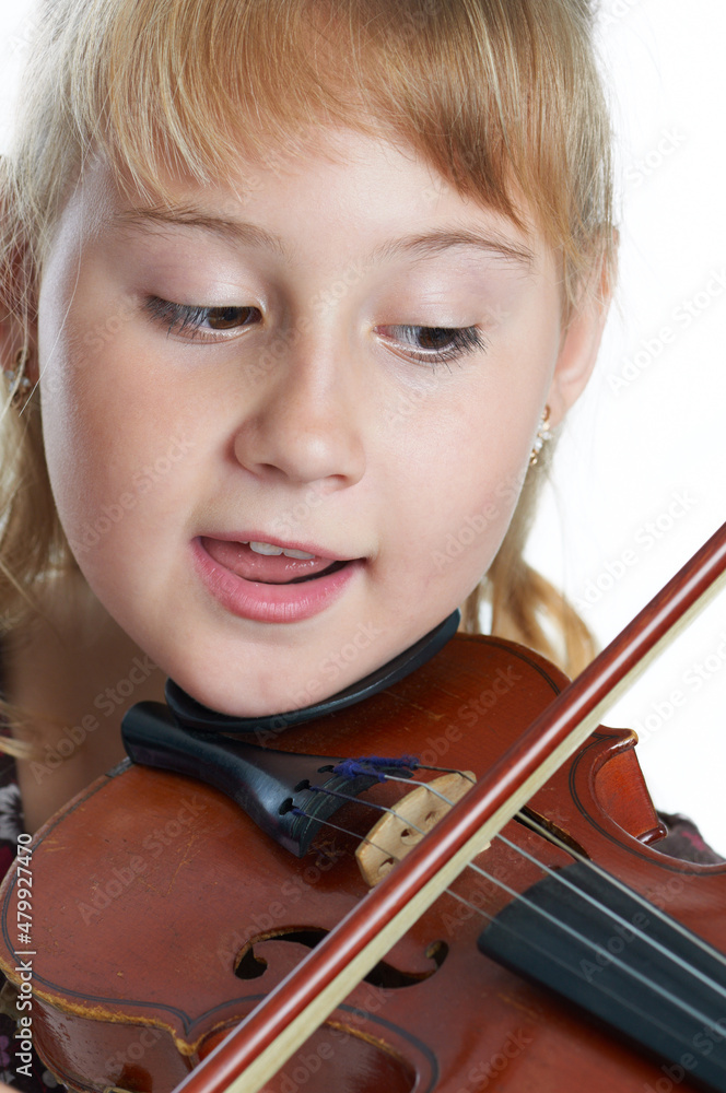 Beautiful little girl playing on violin. Isolated on the white background. Beautiful little girl playing on violin. Isolated on the white background.