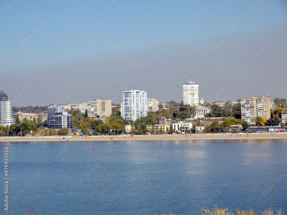 View from the shores of the island of Khortytsia on the Dnieper industrial city of Zaporozhye covered with a cloud of factory emissions on the horizon.