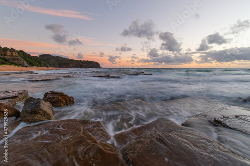 Water flowing on the rocky shore of Turimetta Beach, Sydney, Australia.