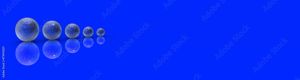 Five balls of metal of different sizes of blue color on blue background. Growth of something. Progress. Reflection. Banner for insertion into site. Horizontal image. 3D image. 3D rendering. Five balls of metal of different sizes of blue color on blue background. Growth of something. Progress. Reflection. Banner for insertion into site. Horizontal image. 3D image. 3D rendering.