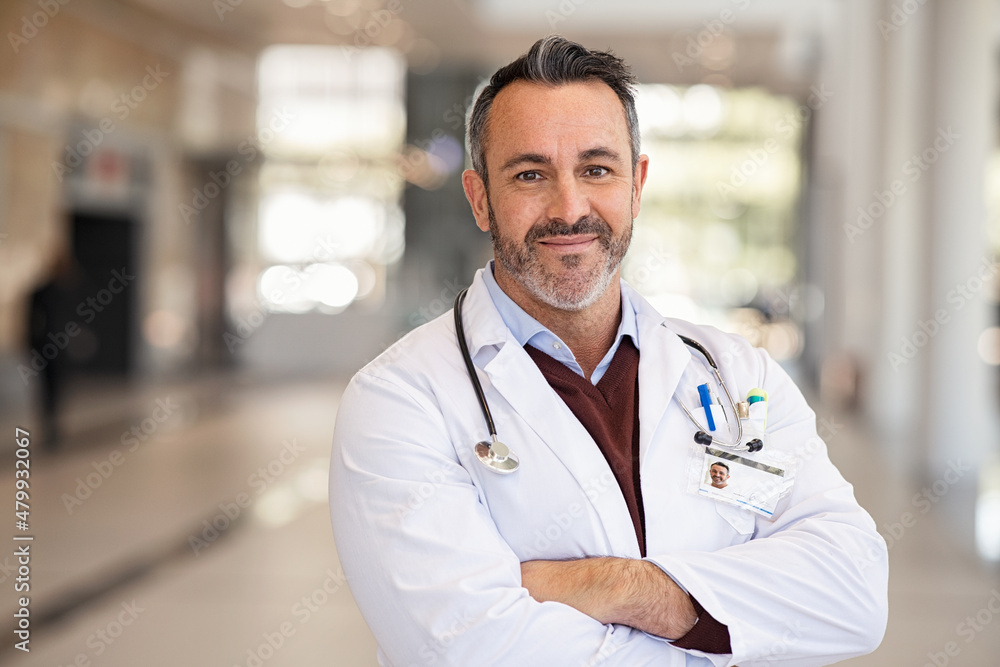 Confident successful mature doctor at hospital Confident successful mature doctor at hospital