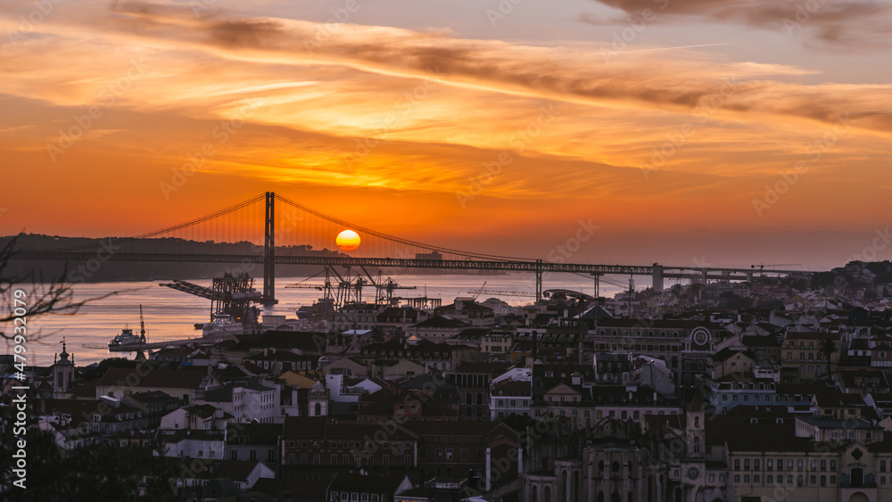 Sunset overlooking Lisbon's Baixa and 25 April Bridge on the Tagus River, Portugal