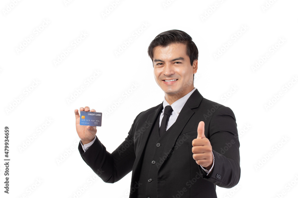 Handsome business man in black suit thumbs up and holding credit card isolated on white background. Business, technology, ecommerce and online payment concept. Handsome business man in black suit thumbs up and holding credit card isolated on white background. Business, technology, ecommerce and online payment concept.