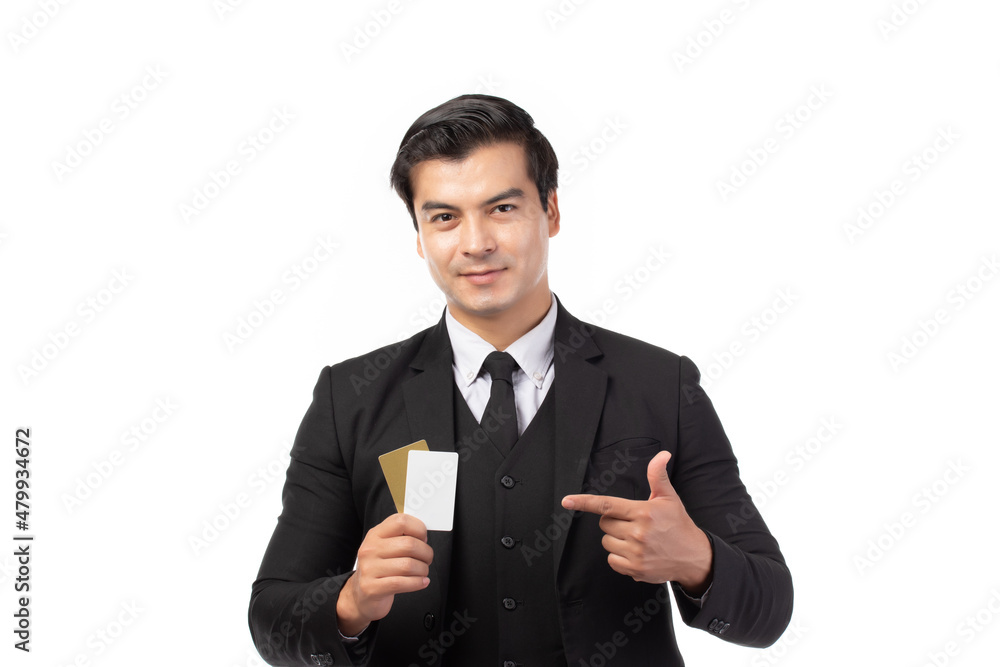 Handsome business man in black suit holding and finger pointing to credit card isolated on white background. Business, technology, ecommerce and online payment concept. Handsome business man in black suit holding and finger pointing to credit card isolated on white background. Business, technology, ecommerce and online payment concept.