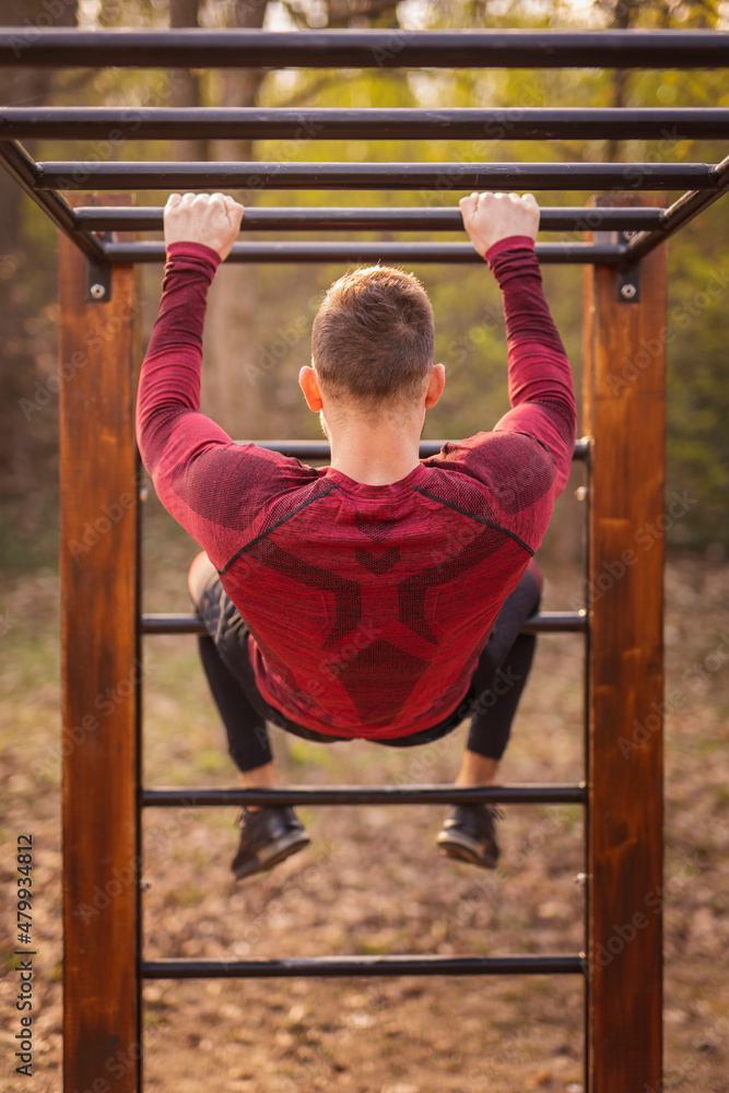 Fototapeta premium Man working out on monkey bars