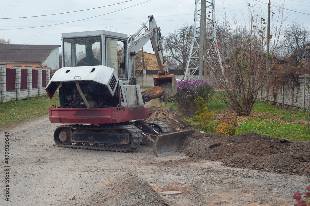 Crawler excavator digging on demolition site. Excavating machine. Earth moving equipment. Excavation vehicle.