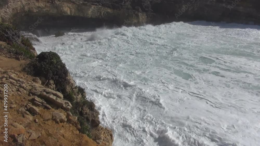 Breaking ocean waves, shore destroyed by water, caves washed out by waves, ocean waves crashing into the shore, tide washing the shore, volcanic rocks near the ocean, white sea foam, salt water splash Breaking ocean waves, shore destroyed by water, caves washed out by waves, ocean waves crashing into the shore, tide washing the shore, volcanic rocks near the ocean, white sea foam, salt water splash