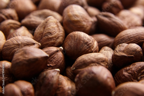 Shelled raw hazelnuts background closeup