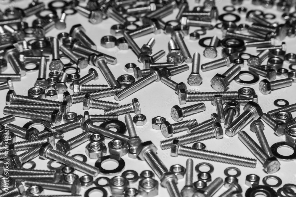 A lot of bolts nuts and washers on a white background. A lot of bolts nuts and washers on a white background.