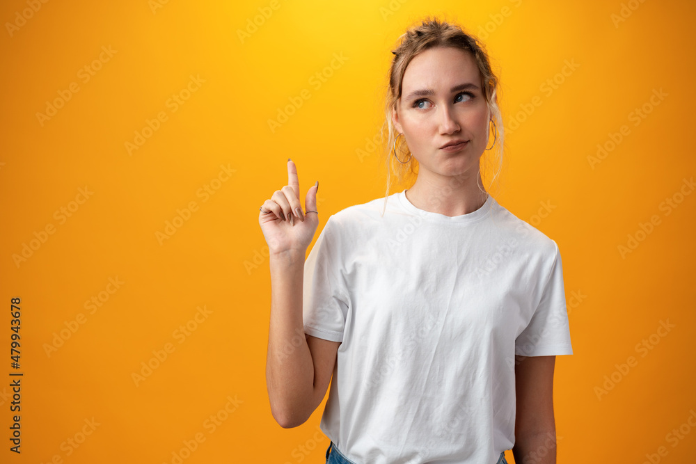 Young beautiful woman thinking looking to the side against yellow background Young beautiful woman thinking looking to the side against yellow background