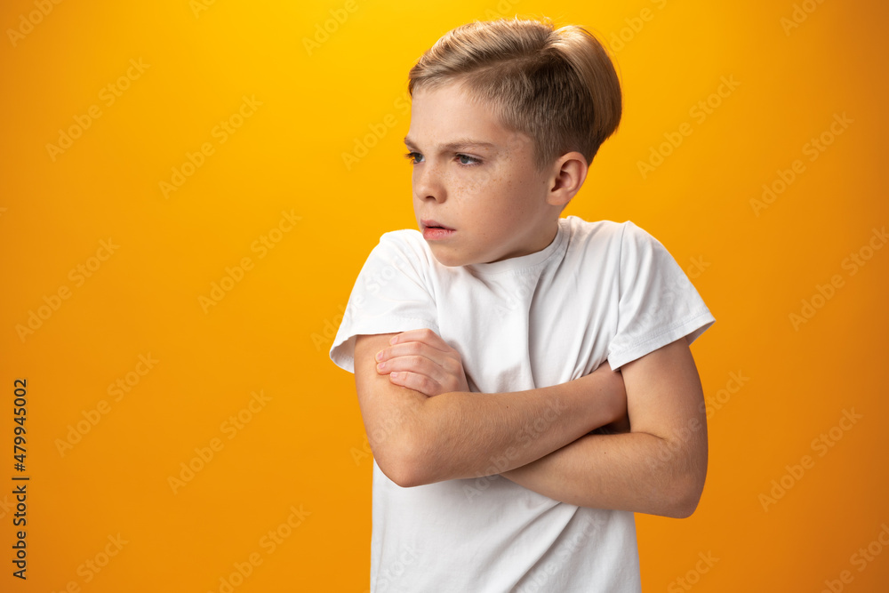Portrait of naughty little boy against yellow background Portrait of naughty little boy against yellow background