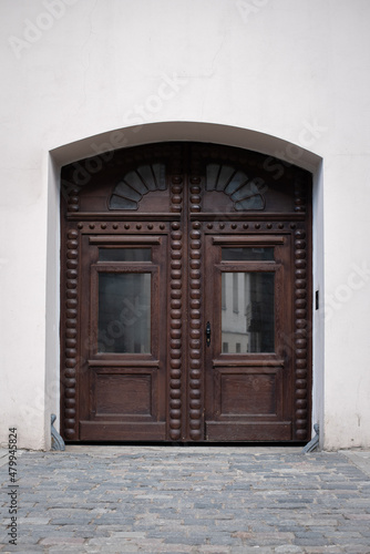 old big and wide wooden door in a stone wall