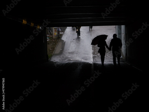 silhouettes people pedestrian underpass
