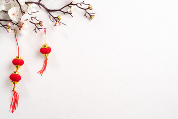 Chinese lunar new year background design concept with white plum flower and festive decoration.