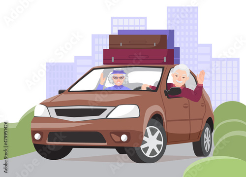 Elderly couple goes on a trip by car. Smiling grandfather waves his hand. There are suitcases on the roof of the car. City landscape in the background. The concept of longevity and an active lifestyle