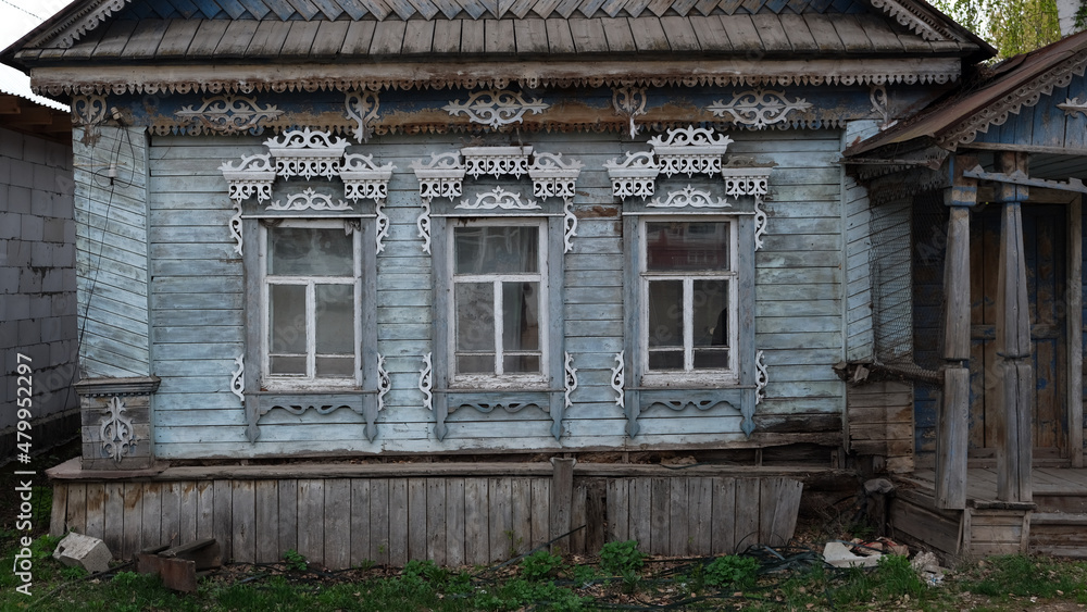 wooden country house with carved patterns on the windows