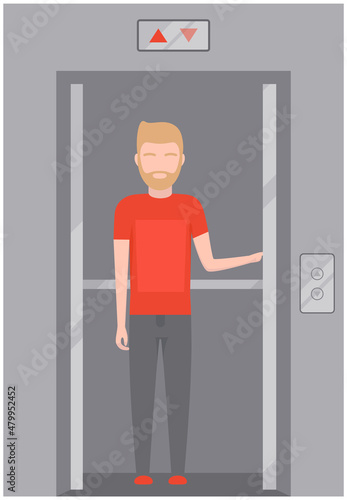Man stands in modern elevator with iron doors. Lifting mechanism of new elevator with up and down buttons. Passenger closes door of lift. Metal lift for transporting people between floors of building