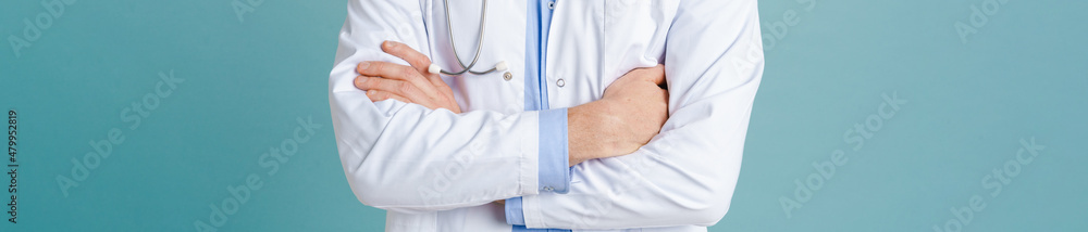 White male doctor wearing lab coat posing with arms crossed White male doctor wearing lab coat posing with arms crossed