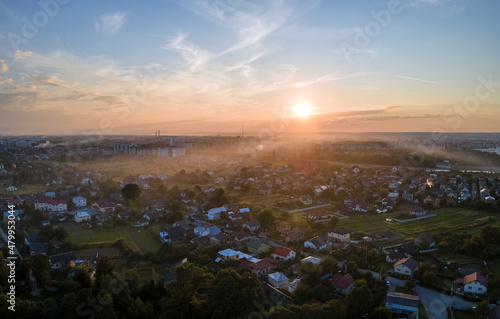 Aerial view of residential houses in suburban rural area at sunset