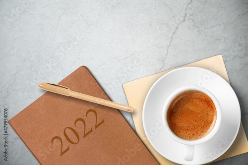 colored diary for the year 2022, pen, coffee latte. New year planning concept.