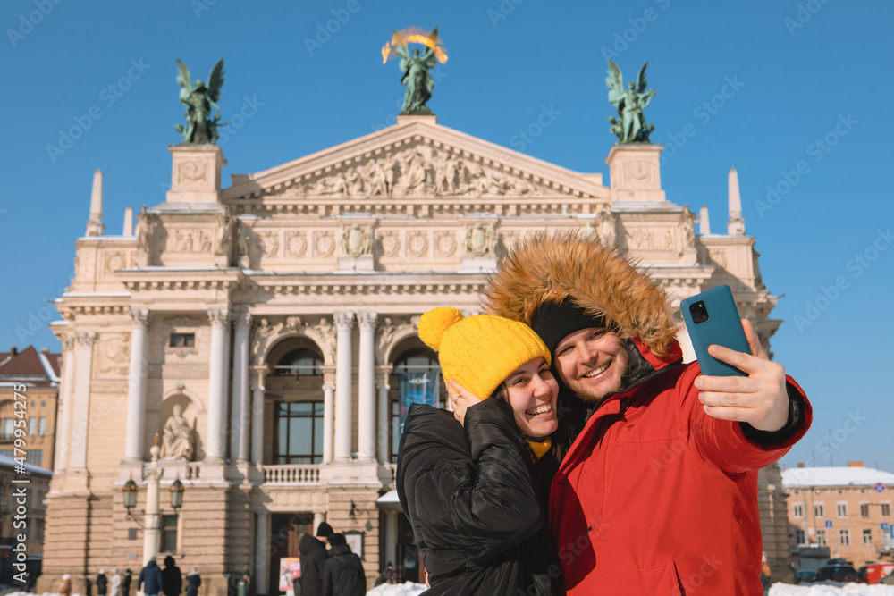 couple tourists taking selfie in front of opera building