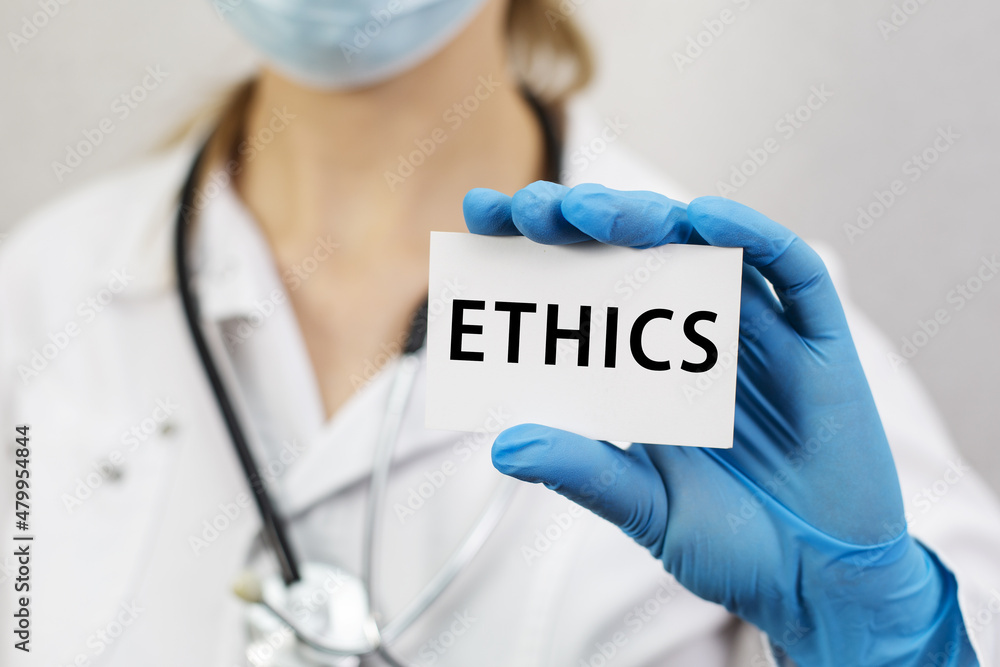 Doctor with stethoscope holding a card with text Ethics. Doctor with stethoscope holding a card with text Ethics.