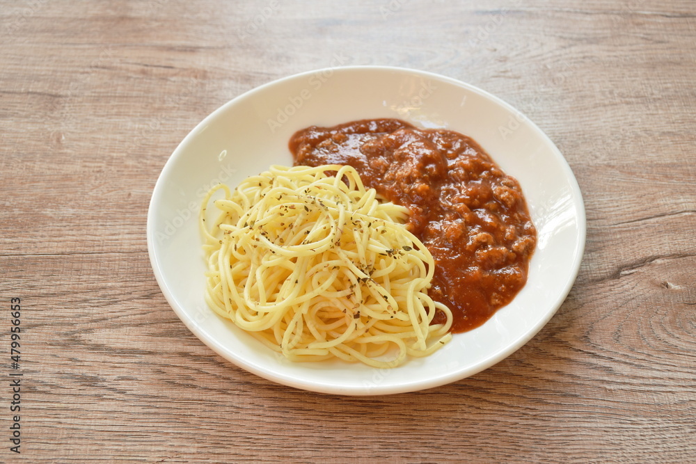 spaghetti dressing fried chop pork and slice tomato in ketchup sauce on plate spaghetti dressing fried chop pork and slice tomato in ketchup sauce on plate
