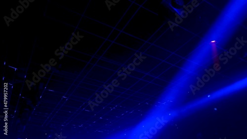 robotic blue lasers lighting up a nightclub dance floor