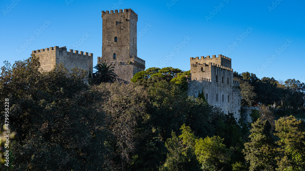 Erice, Sicily, Italy. Glimpse of Venus Castle with trees and blue sky