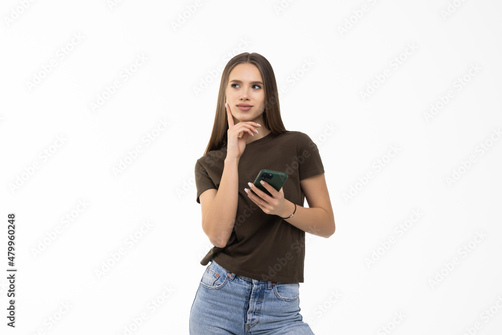 Thinking thoughtful young woman posing isolated over white wall background using mobile phone. Thinking thoughtful young woman posing isolated over white wall background using mobile phone.