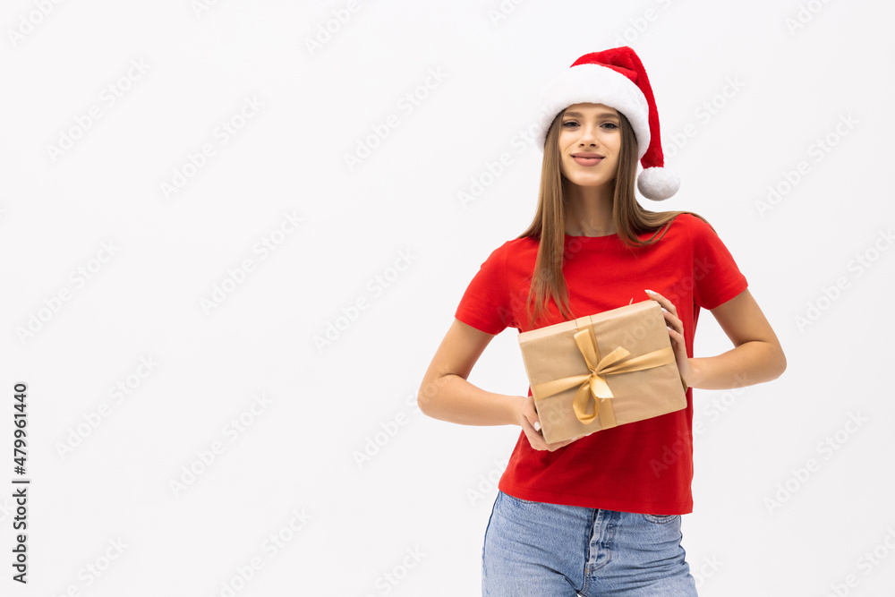 Cheerful young woman in santa hat with presents isolated on white background. Cheerful young woman in santa hat with presents isolated on white background.