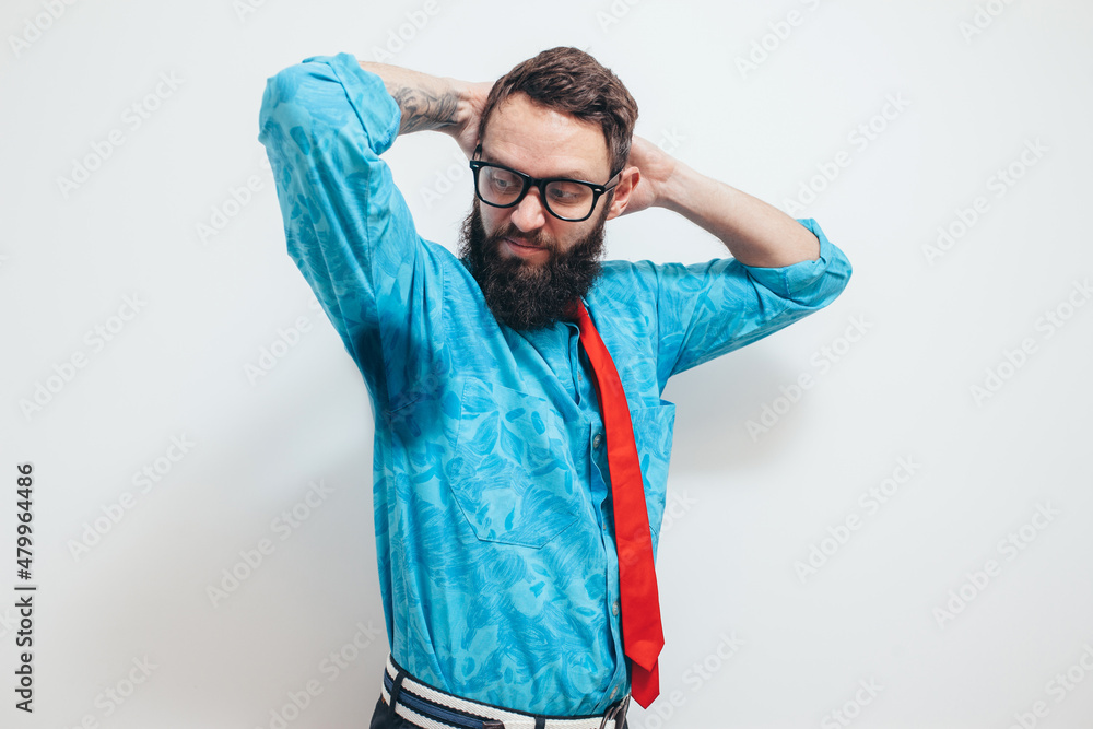 The young man is worried and shows a problem with sweating. Hyperthyroidism concept. Sweat stain on clothes The young man is worried and shows a problem with sweating. Hyperthyroidism concept. Sweat stain on clothes