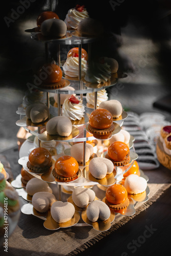 Dessert table for a party. Ombre cake, cupcakes, sweetness and other sweets. Vertical view for social media