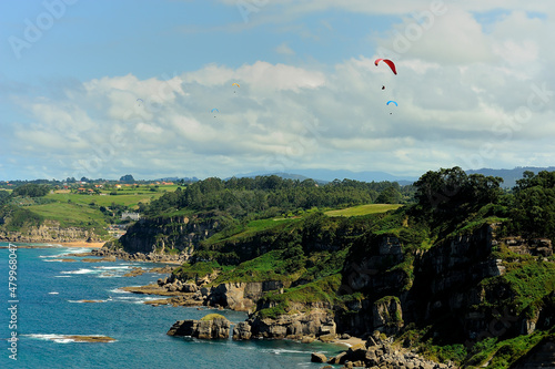 Group of paragliding over Asturias coast.