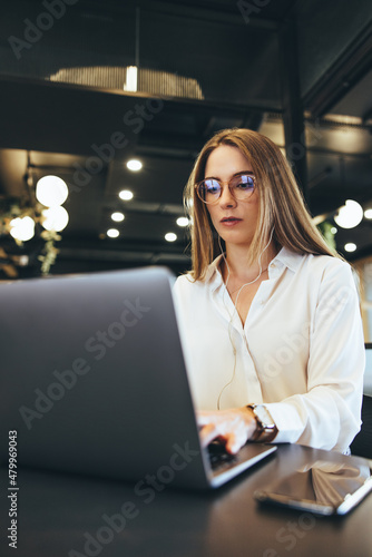 Young businesswoman working on a laptop in a modern workspace