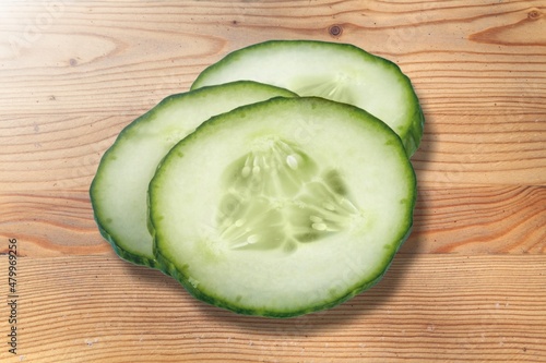 Slices of fresh ripe green cucumber on the desk