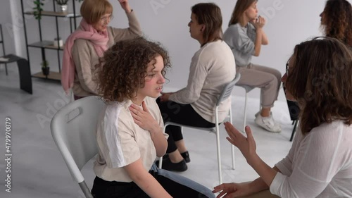 Womens circle concept. Girls sit in pairs opposite each other and talk in the psychologists office. Psychological help, mental health