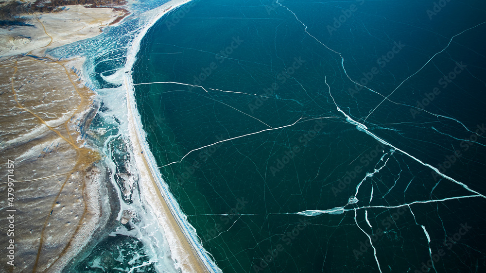 Transparent ice of frozen Lake Baikal in january. Winter natural background. Aerial photography. Transparent ice of frozen Lake Baikal in january. Winter natural background. Aerial photography.