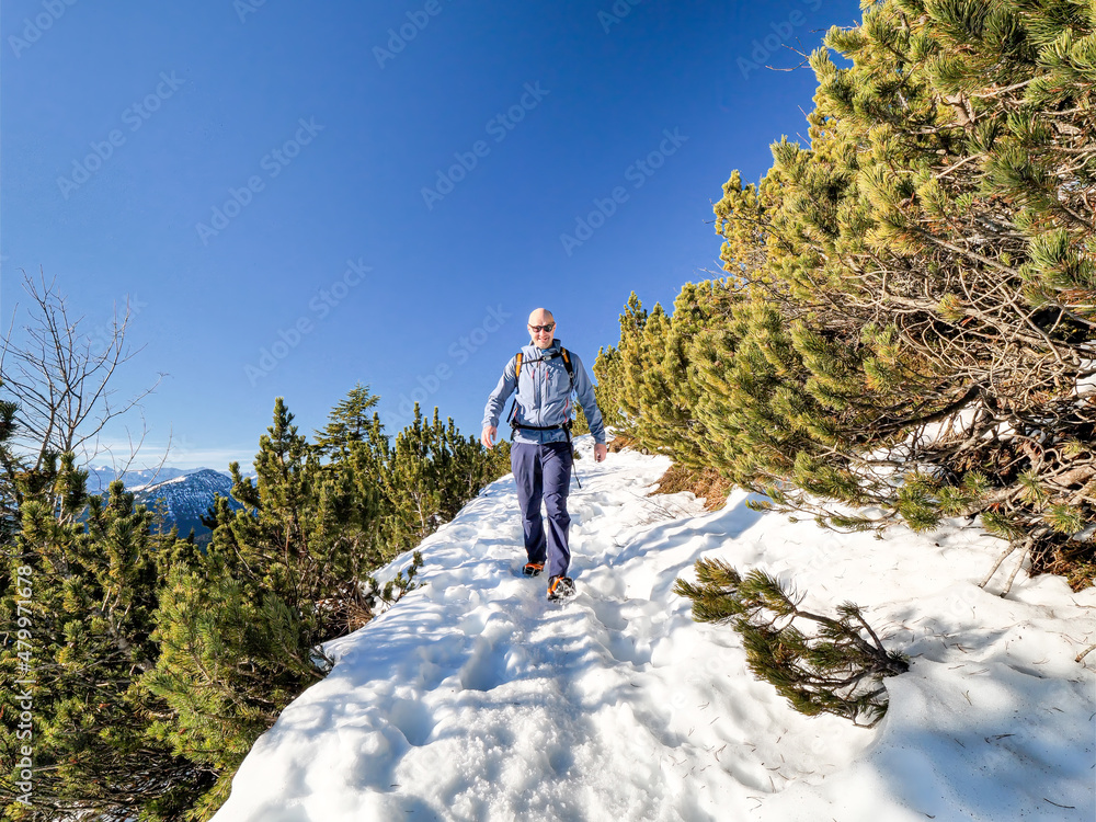 Bavarian Man with hiking activities along the outdoor peak trails