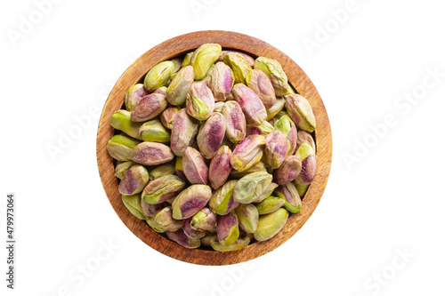 pistachios nuts peeled in wooden bowl isolated on white background. Vegan food, top view.