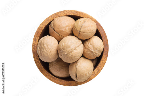 shelled walnut, chilean in wooden bowl isolated on white background. Vegan food, top view. photo