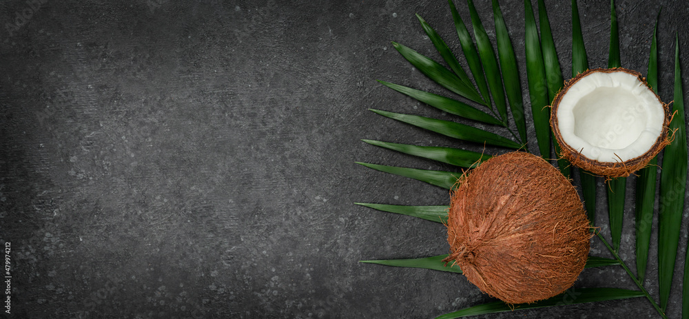 Coconuts on dark background, superfoods concept. Copy space, overhead. Coconuts on dark background, superfoods concept. Copy space, overhead.