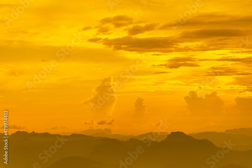 Landscape photo of sunset over clouds with mountain hill forest. in golden light tone.