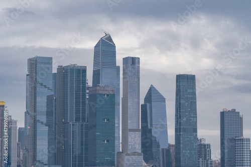 Manhattan skyscrapers with cloudy sky in the background, overcast day.