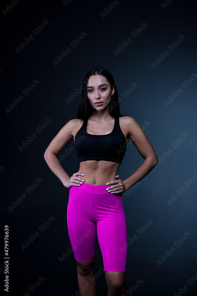 Athletic natural woman body on dark background.
Athletic natural woman body on dark background.