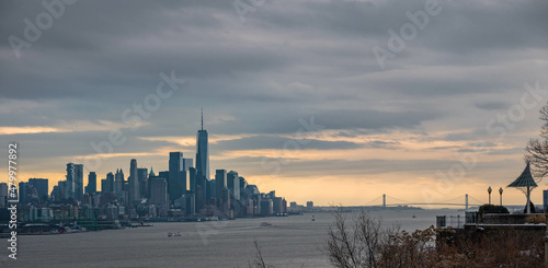 sunset over the river, downtown Manhattan NYC , taken from NJ side. Vivid clouds in the background